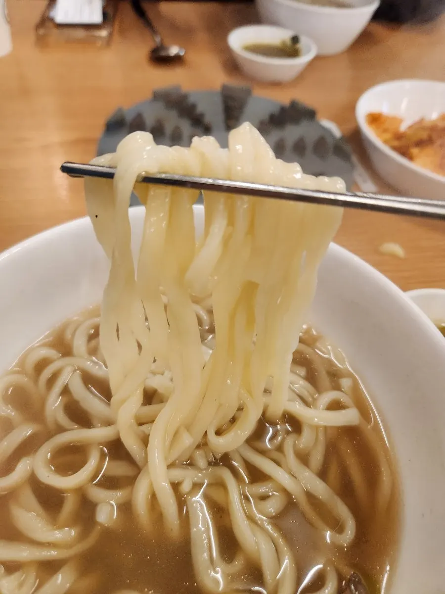 Kalguksu noodles scooped into a personal bowl