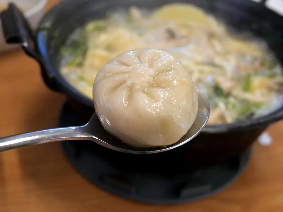 Minari being cooked in the boiling broth