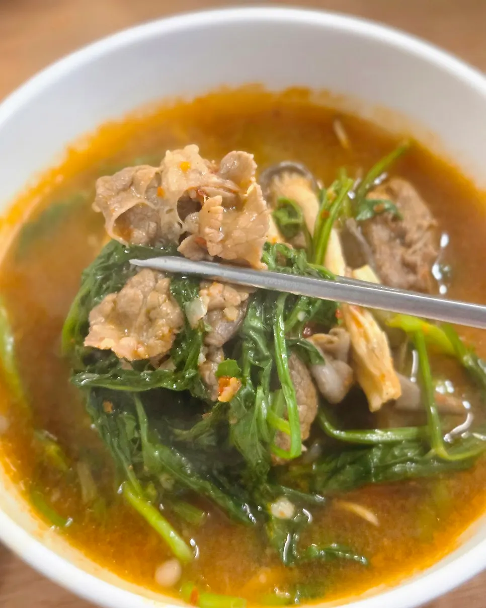 Mushrooms and potatoes in the boiling spicy broth