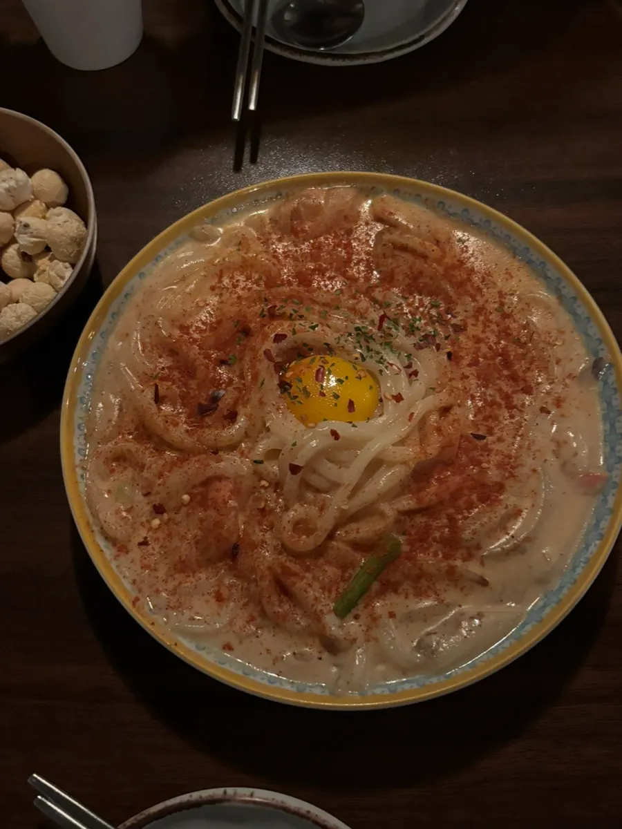 Sangbong cream udon and ugly cheese egg roll set on the table