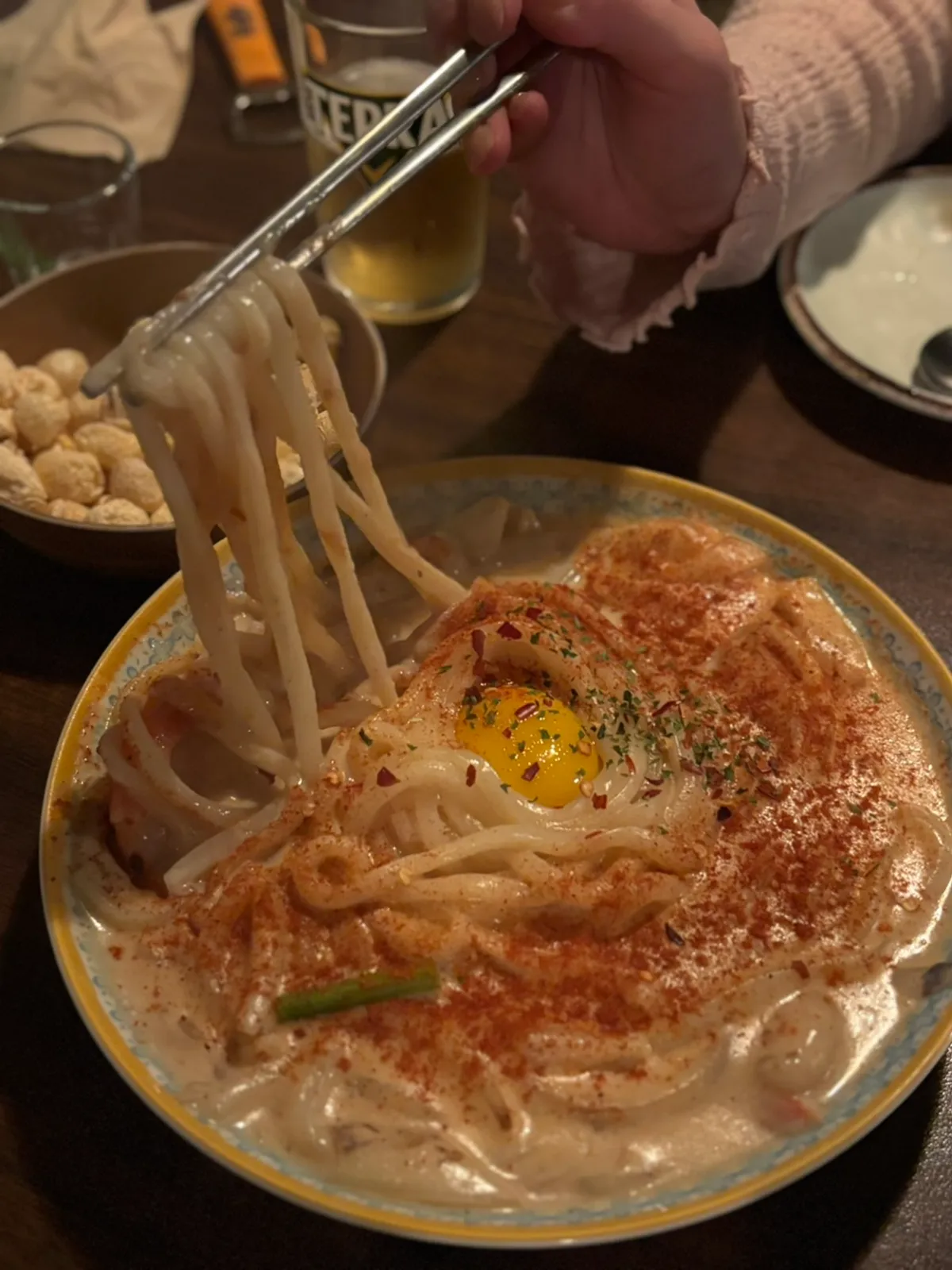 Sangbong cream udon topped with shrimp and garlic scapes