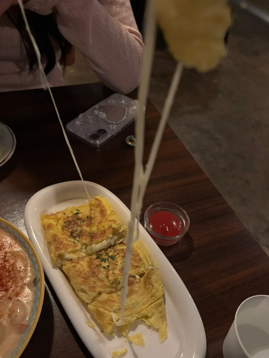 Cross-section of the egg roll showing stretchy cheese inside