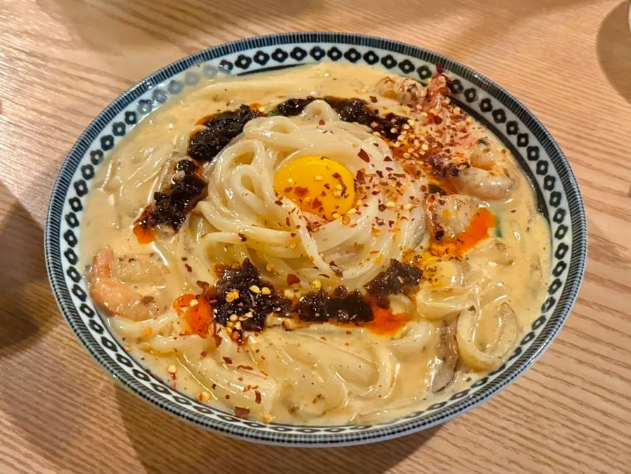 Mala cream udon drizzled with mala sauce over cream sauce