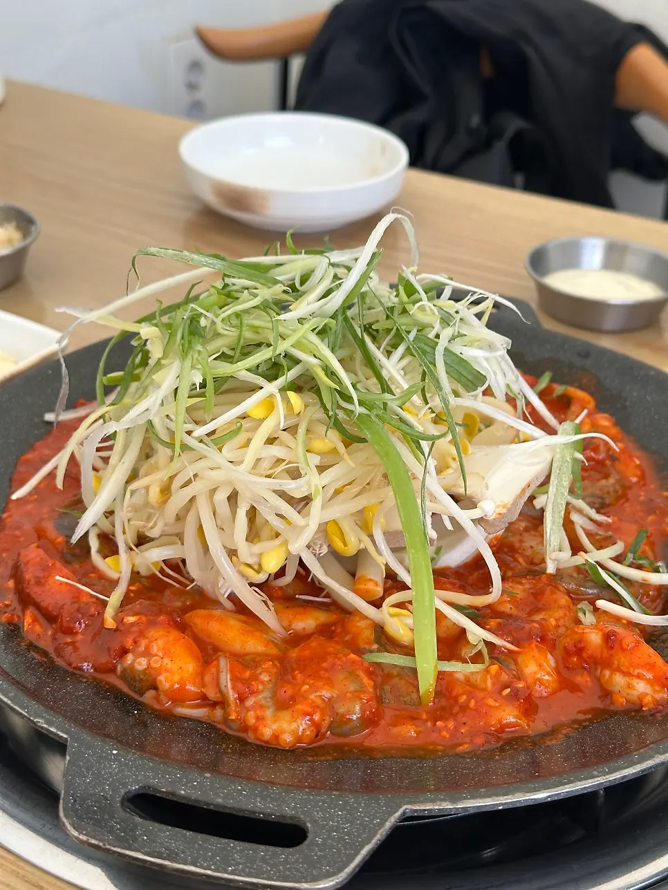 Raw jjukkumi and sauce laid out on the hot plate