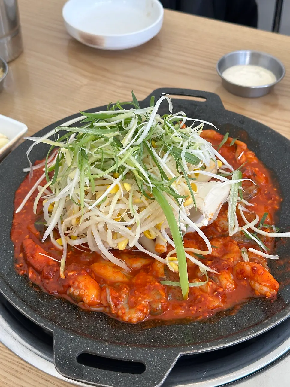 Staff member cooking the jjukkumi on the hot plate