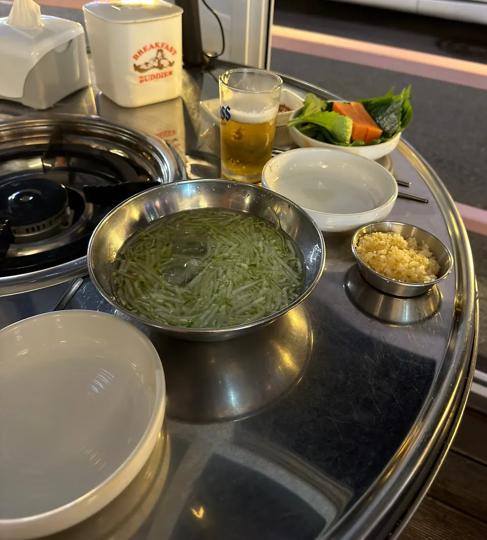Basic side dishes: pickled radish, vegetables, flying fish roe, and cold cucumber soup