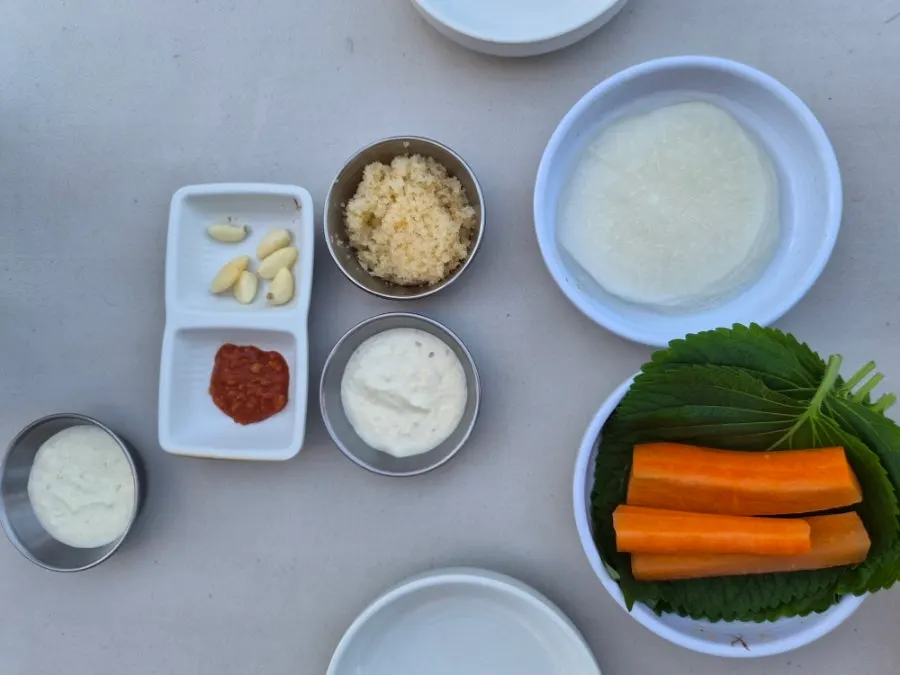 Basic side dish spread with pickled radish, perilla leaves, and flying fish roe