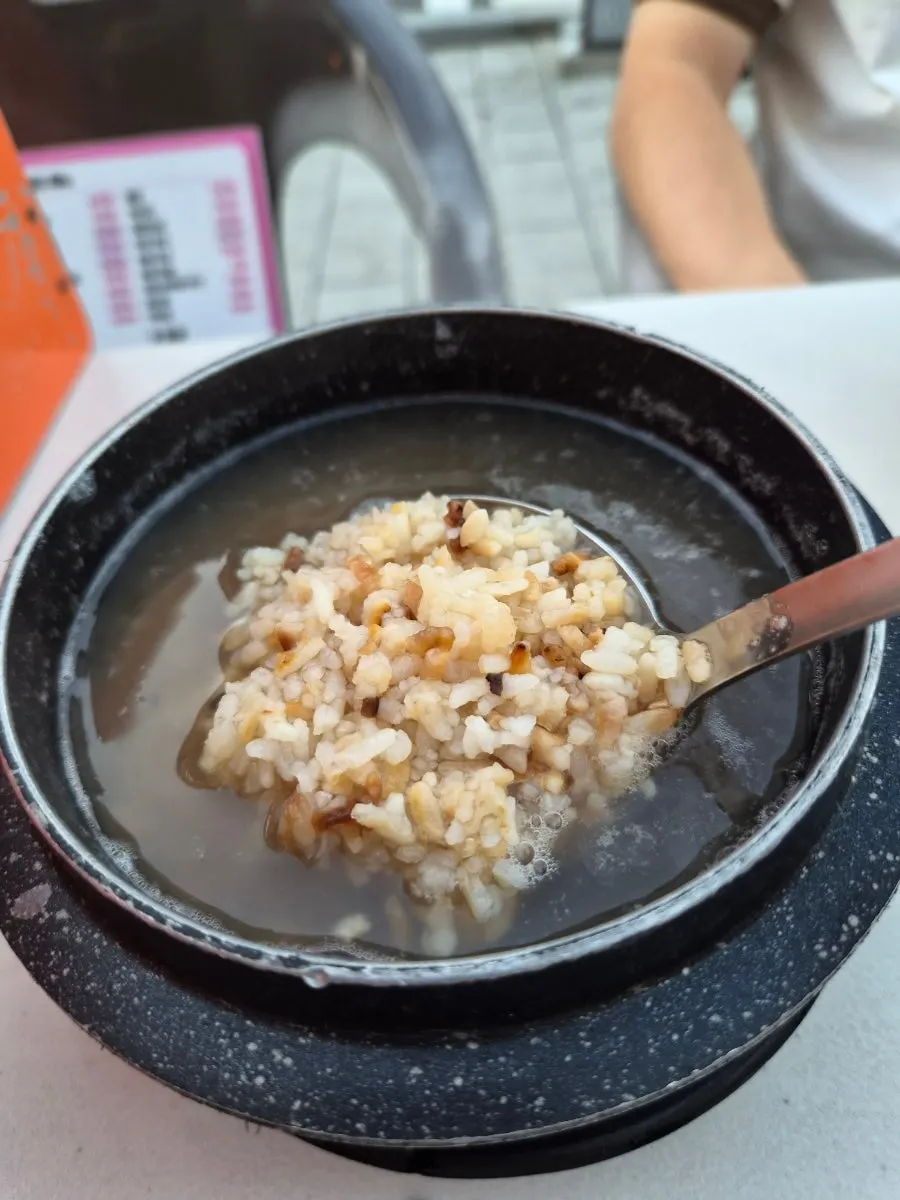 A bite of jjuksam wrapped in a ssam