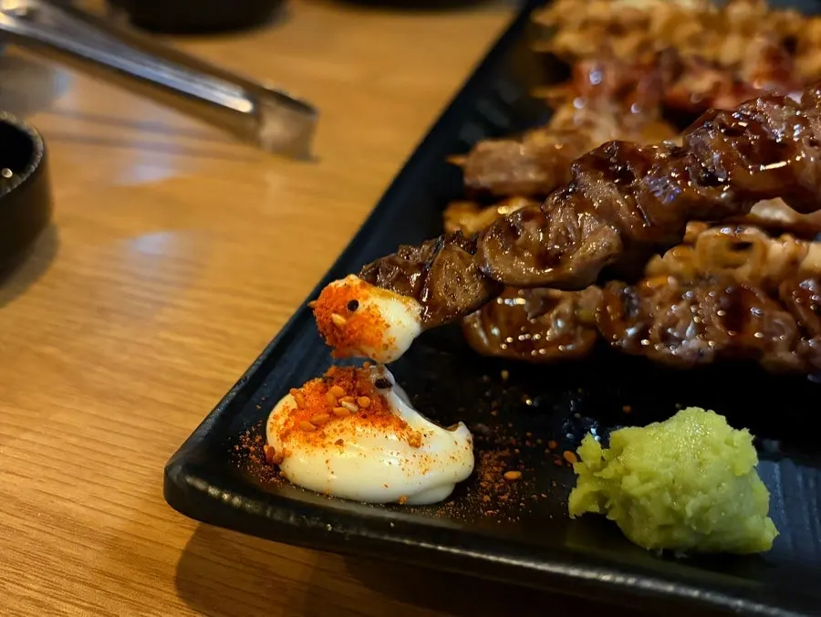 Charcoal-scented skewers eaten with sauce