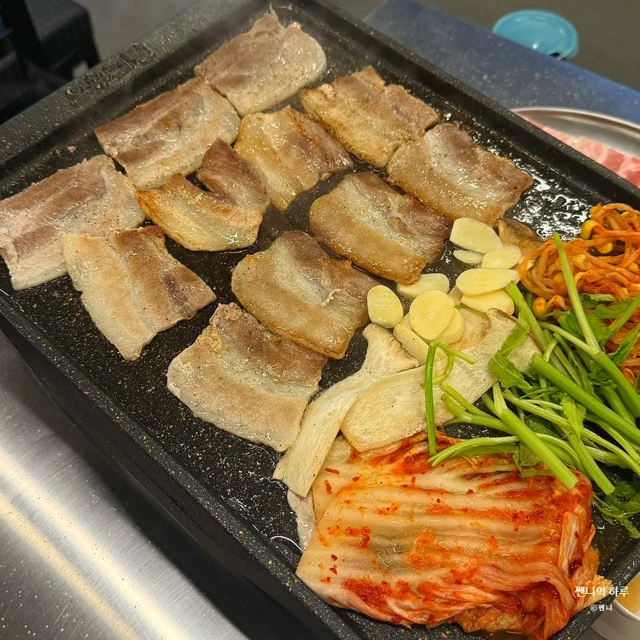 Frozen pork belly cooking on the grill