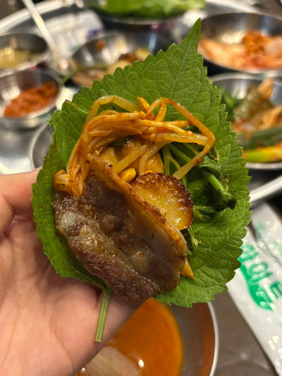 Pork belly wrap topped with lettuce