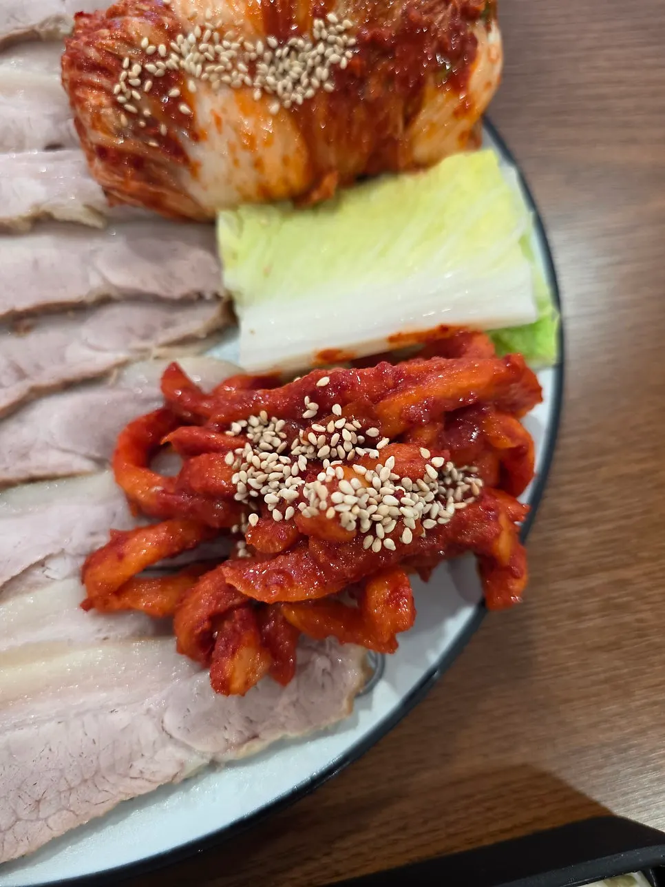 Bossam set with radish kimchi and napa cabbage wraps
