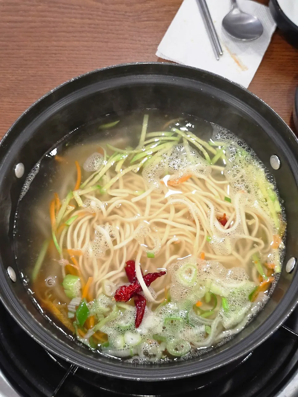 Seafood-based kalguksu broth boiling in a pot