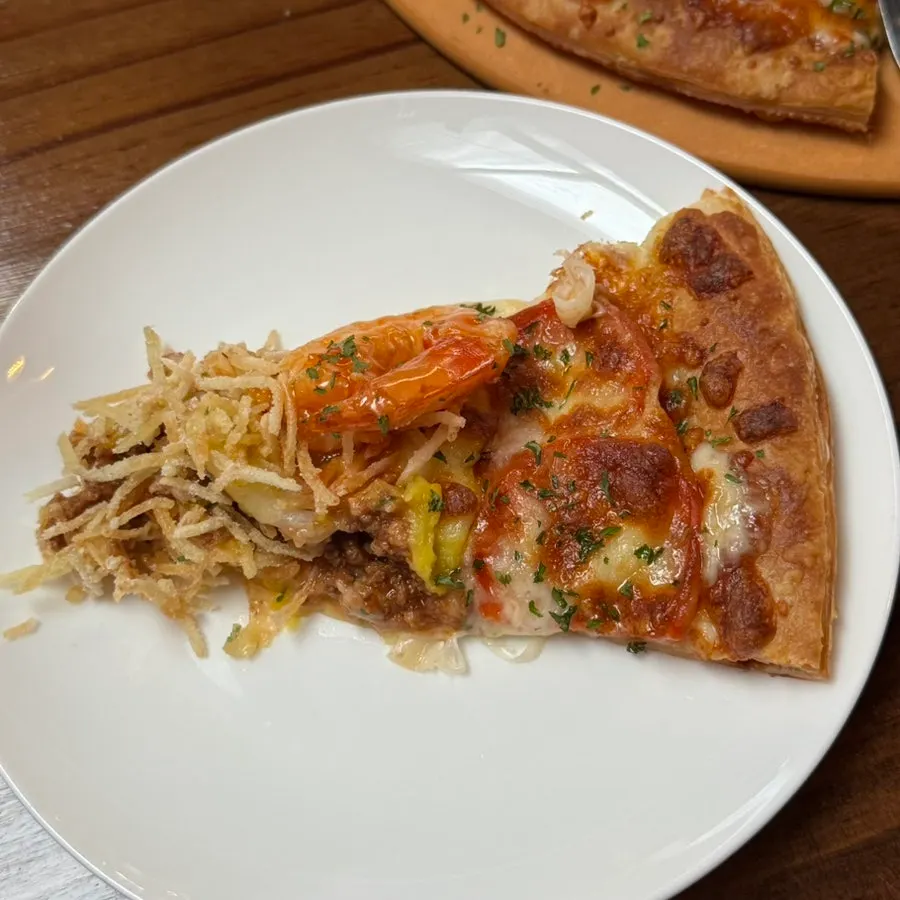 Cross-section of pastry pizza with shredded potato and shrimp