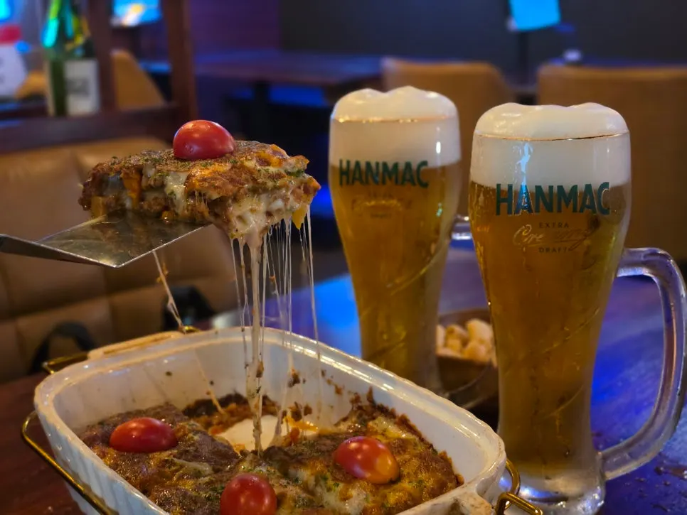 Glass of draft beer with cream dripping down the side