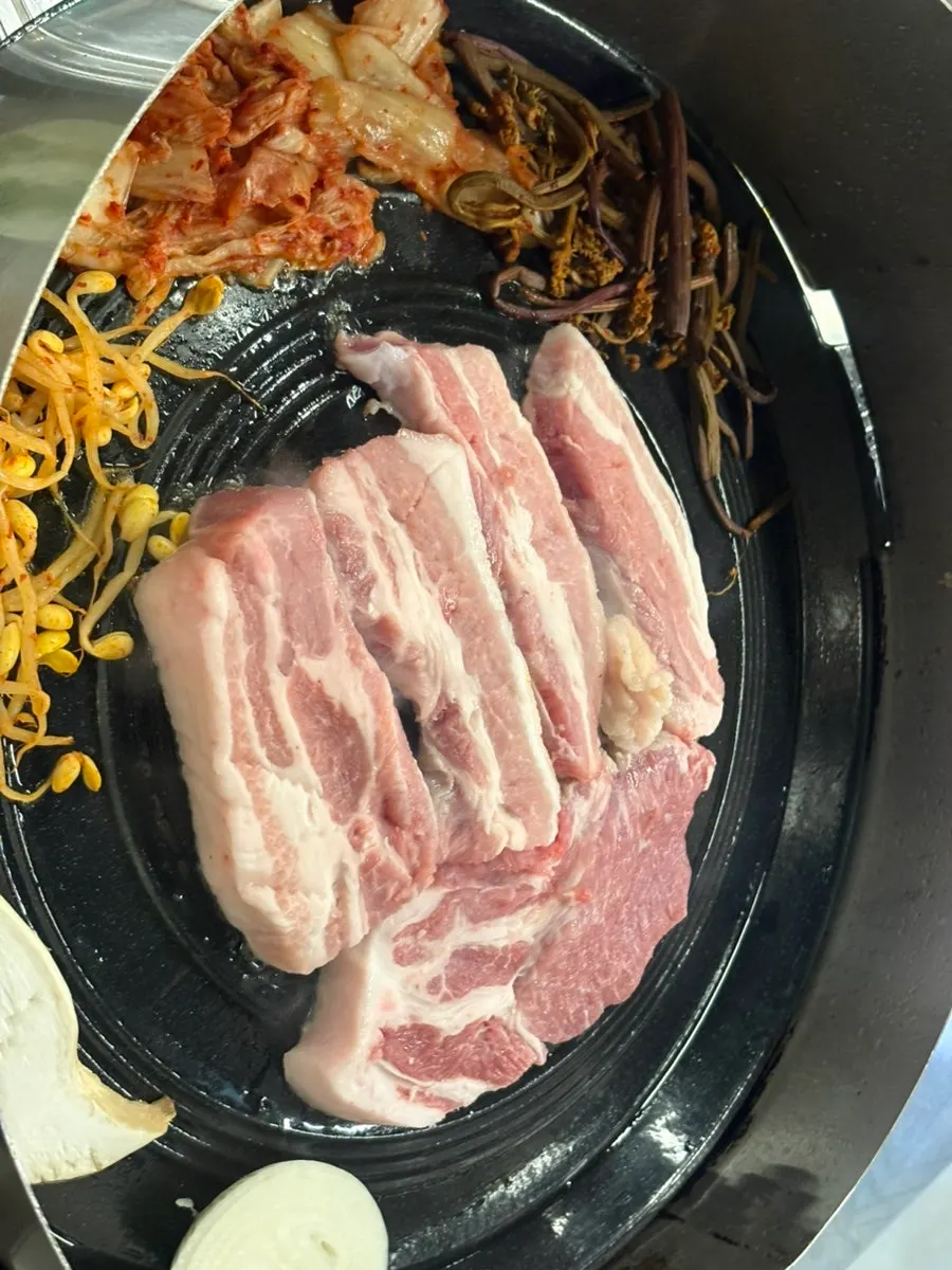 Raw marbled samgyeopsal and pork neck set on the table