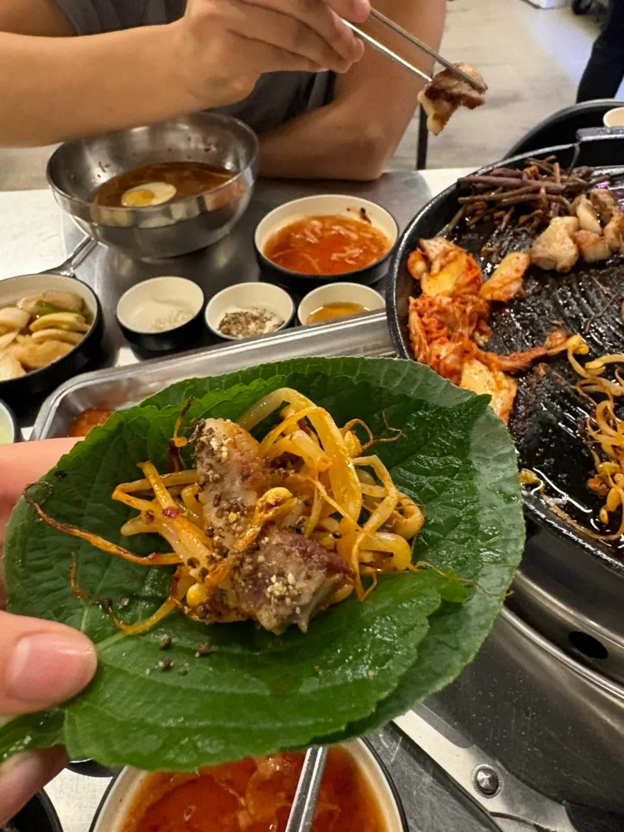 Sweet pumpkin and enoki mushrooms grilling alongside the pork