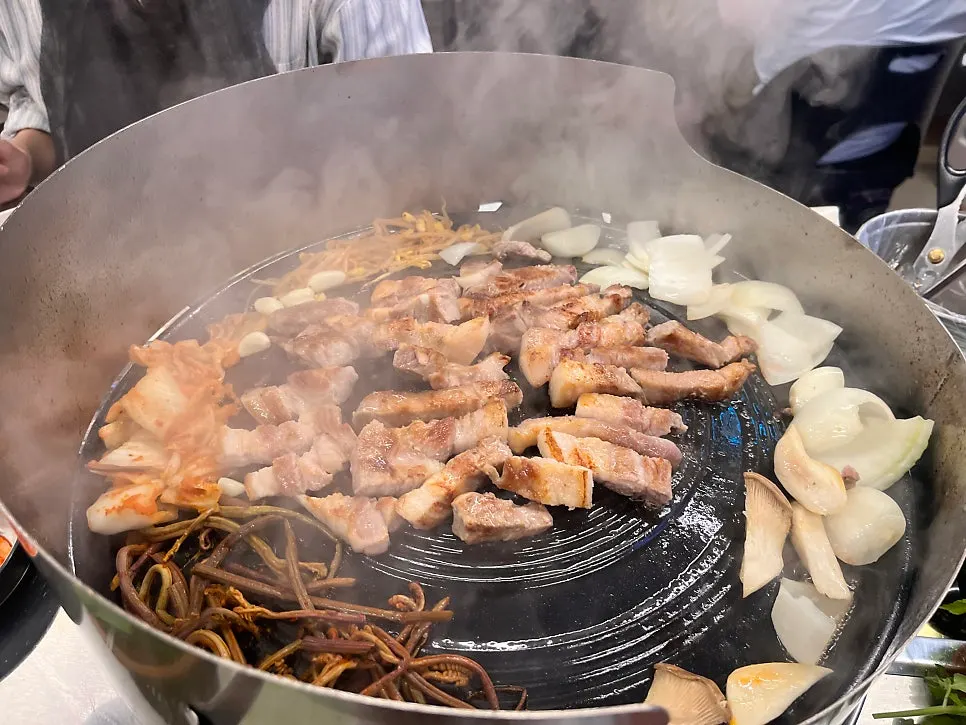 Staff grilling the pork as part of the grilling service