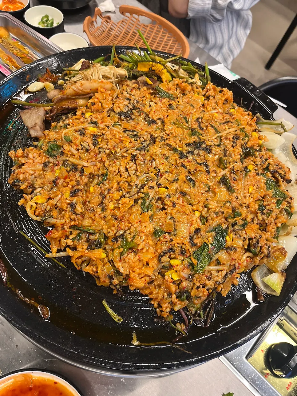 Meat and vegetables grilled together on the cast-iron lid