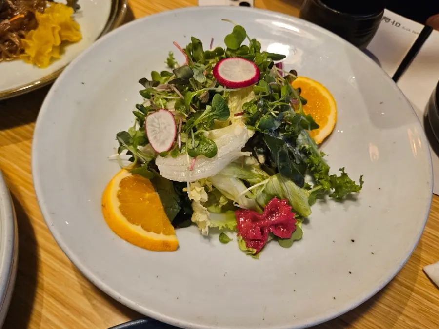Orange butterfly salad topped with butterfly-shaped pasta noodles