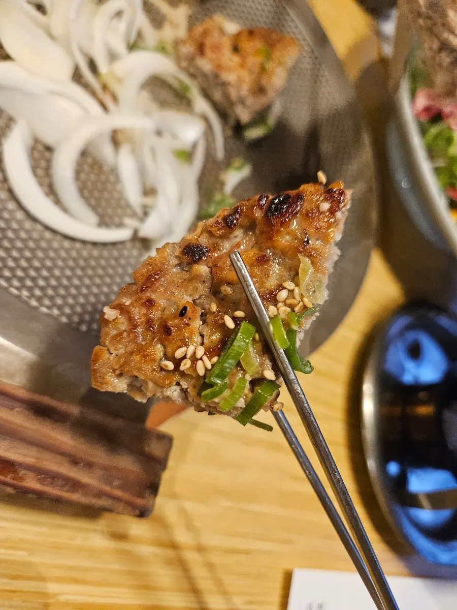 Tteokgalbi and onions on the induction burner