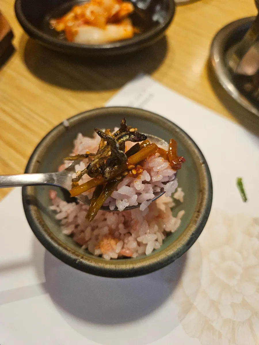 Doenjang jjigae boiling on the burner alongside rice