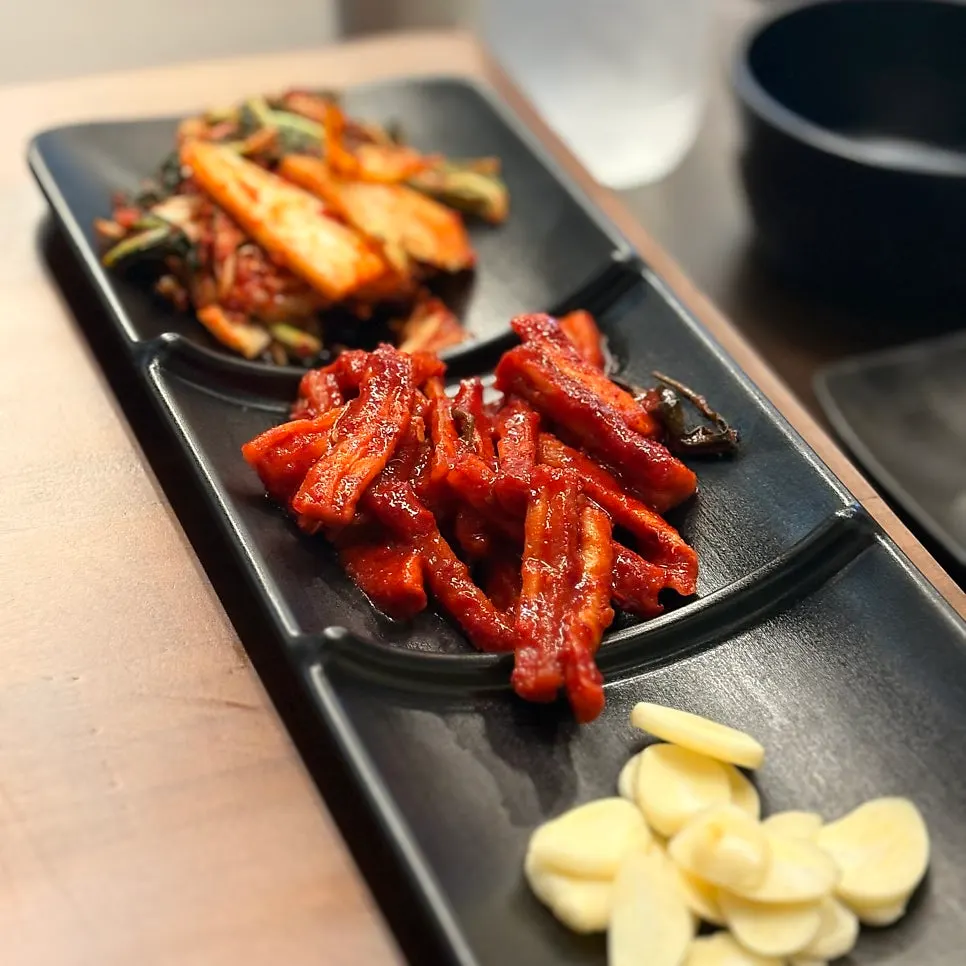 Table setting with salted shrimp, ssamjang and spicy sauce