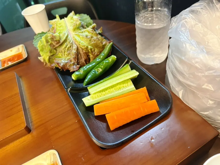 Plate of lettuce, perilla leaf, cucumber and carrot for wraps