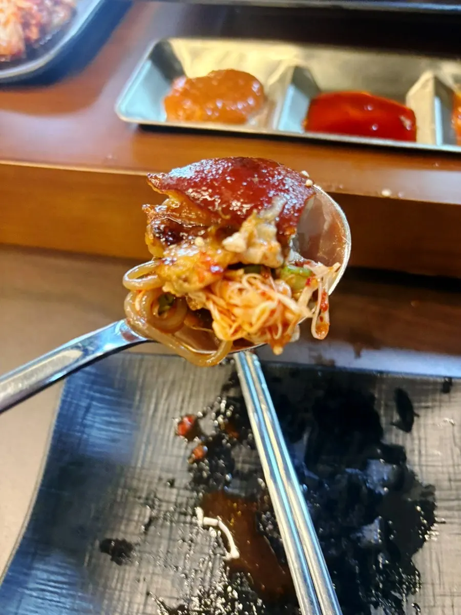 Chopsticks picking up jokbal meat