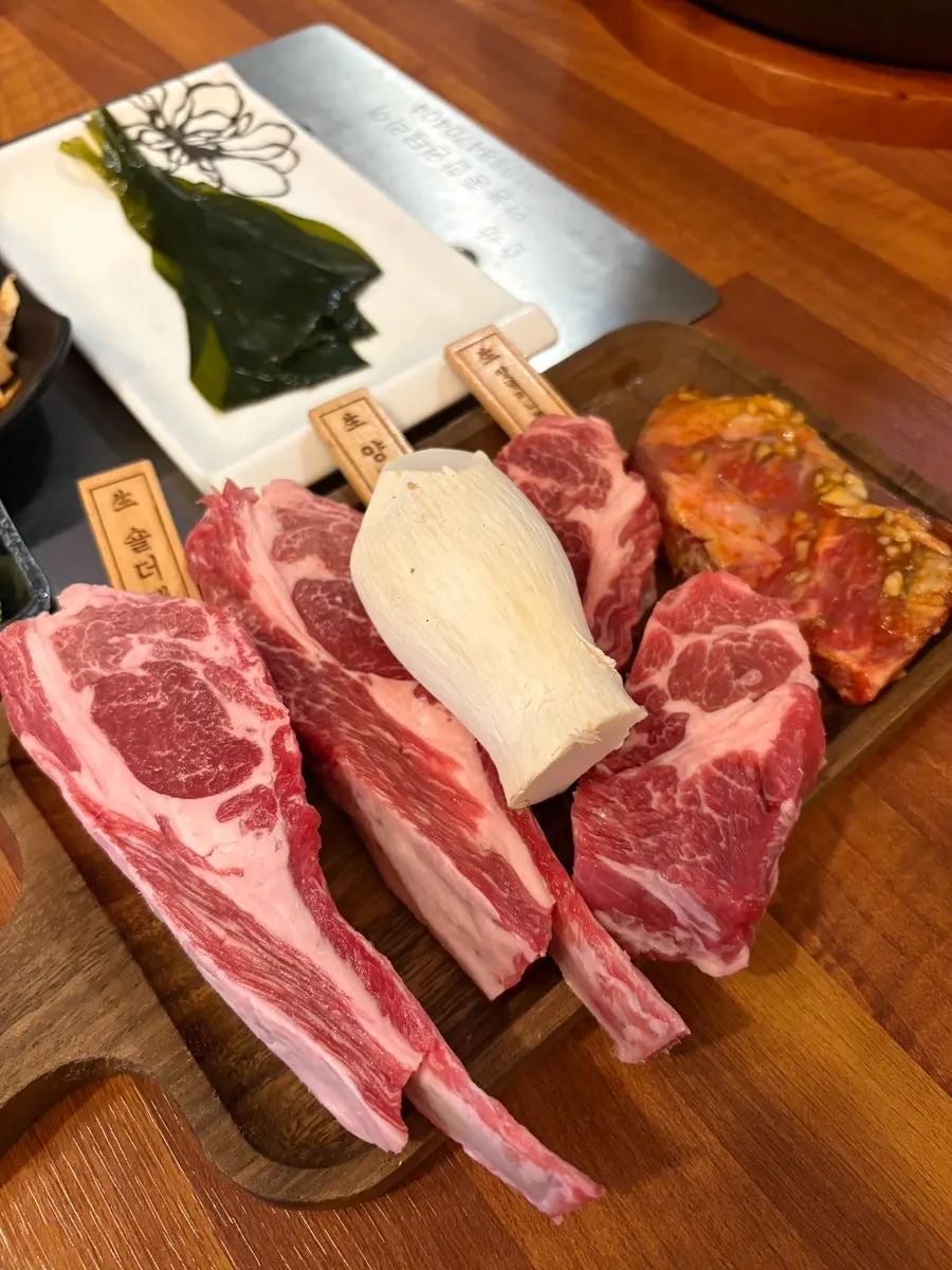 Vertical photo of the menu board listing single-cut lamb items