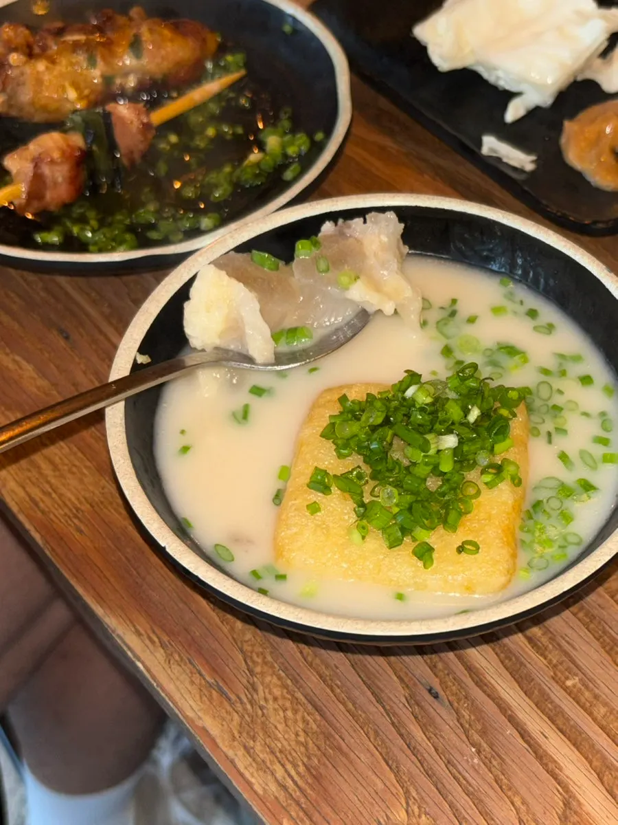 Tsukune dipped in soy sauce mixed with egg yolk