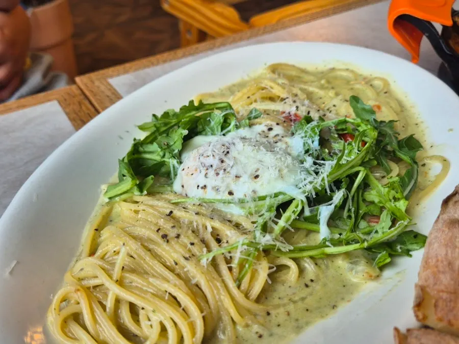 A plate of basil pesto cream pasta