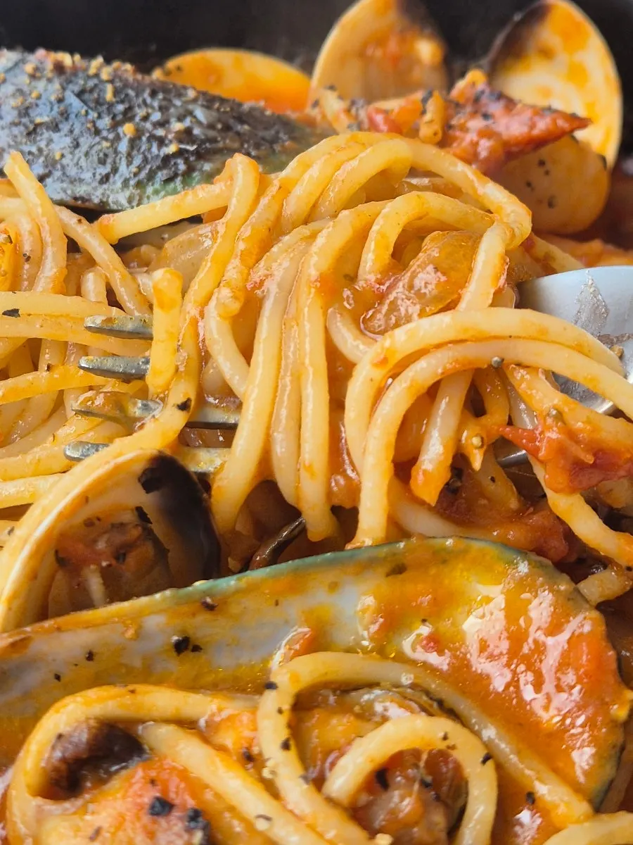 Seafood pasta eaten with sauce
