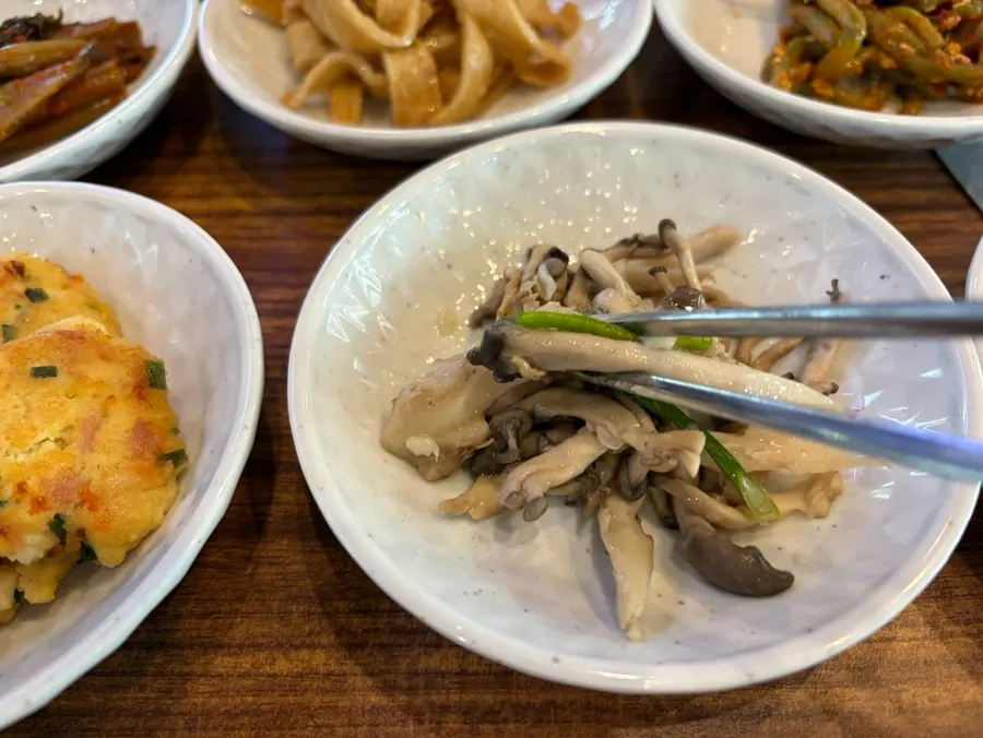 Side dish spread with mustard leaf kimchi and namul at Galchi Hanpan