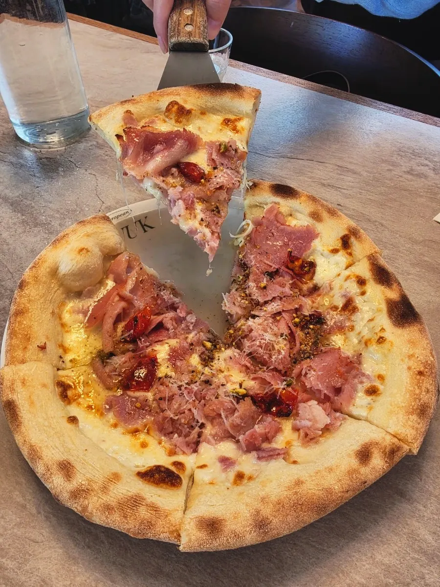 First slice of hot jambon pizza