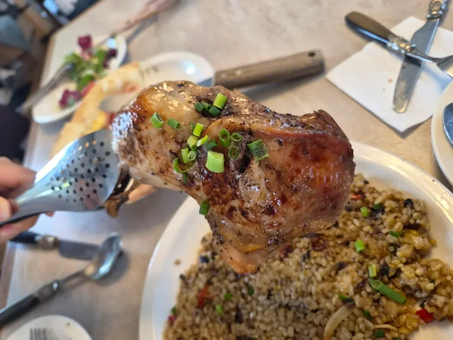 Kung pao chicken pilaf topped with a chicken leg