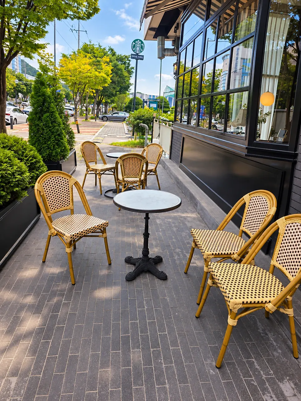 Outdoor round tables next to street trees