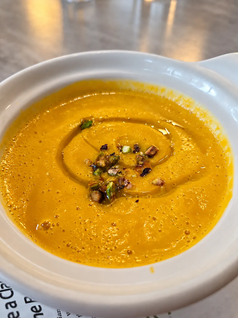 Sweet pumpkin soup in a white bowl
