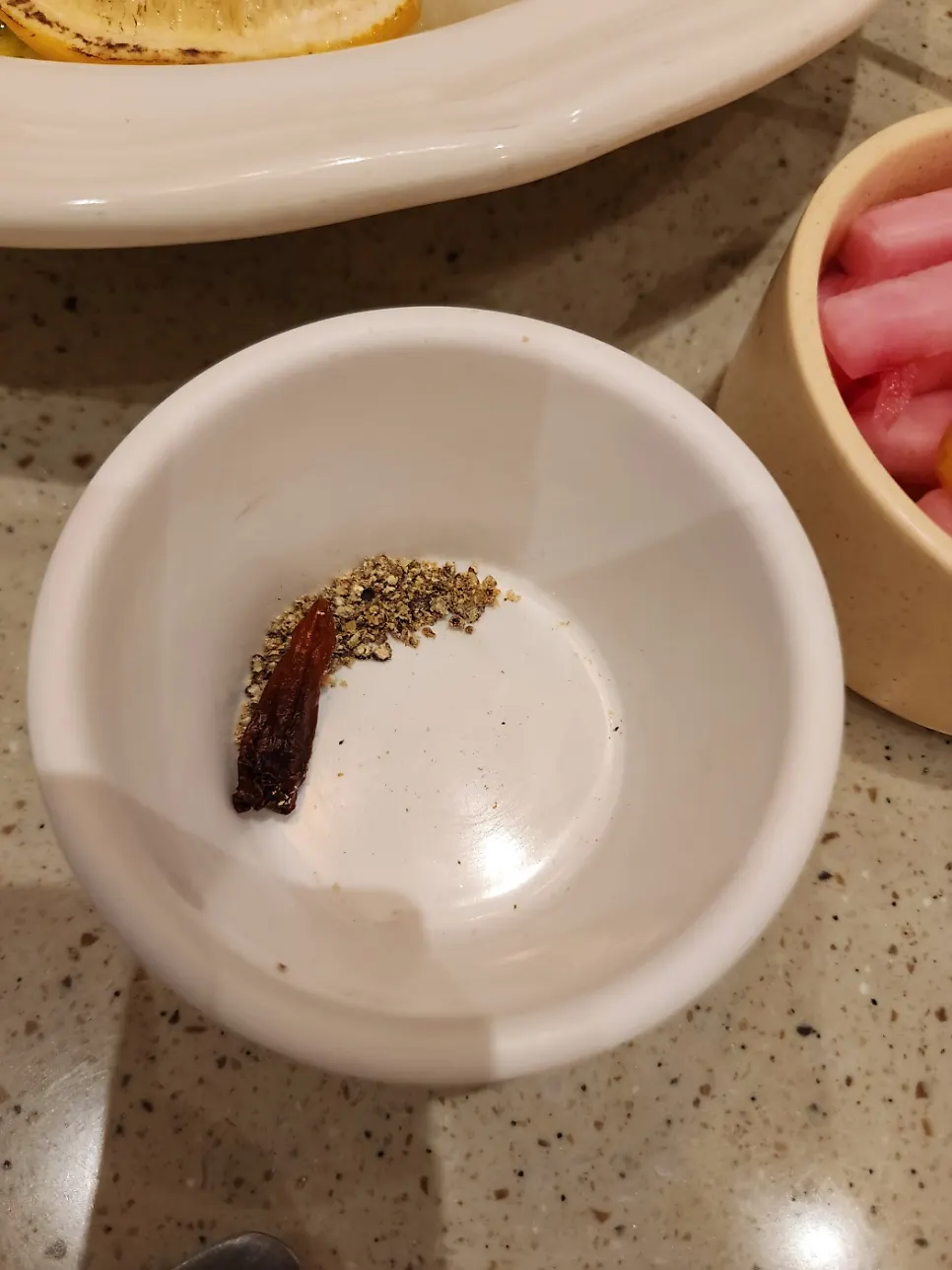 Lemon and plastic gloves served alongside the pasta