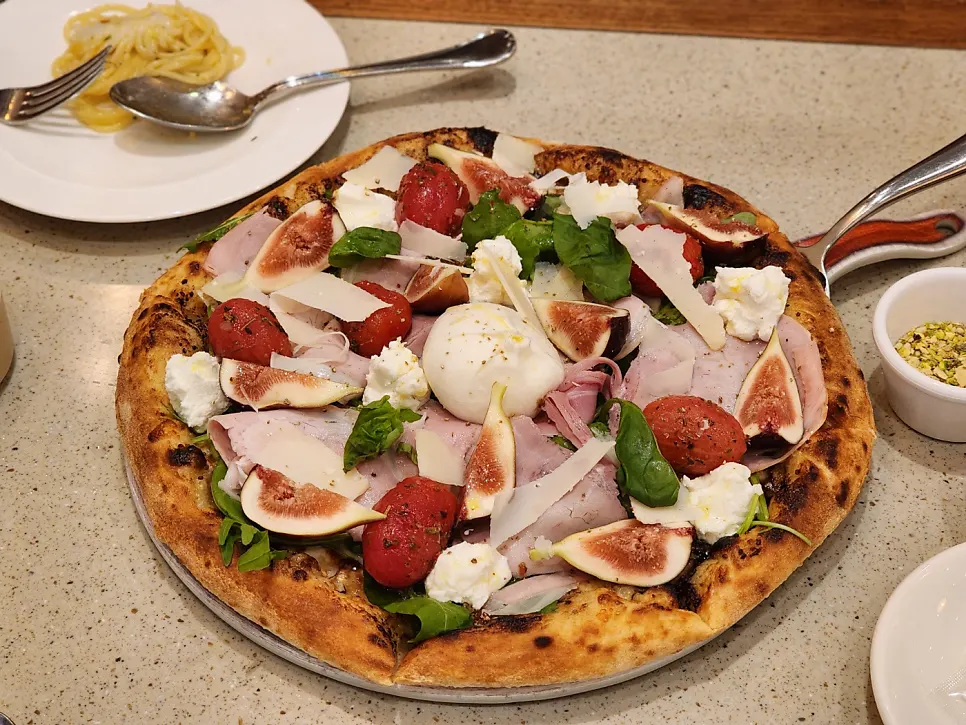 Rolling up the pizza to dip into honey