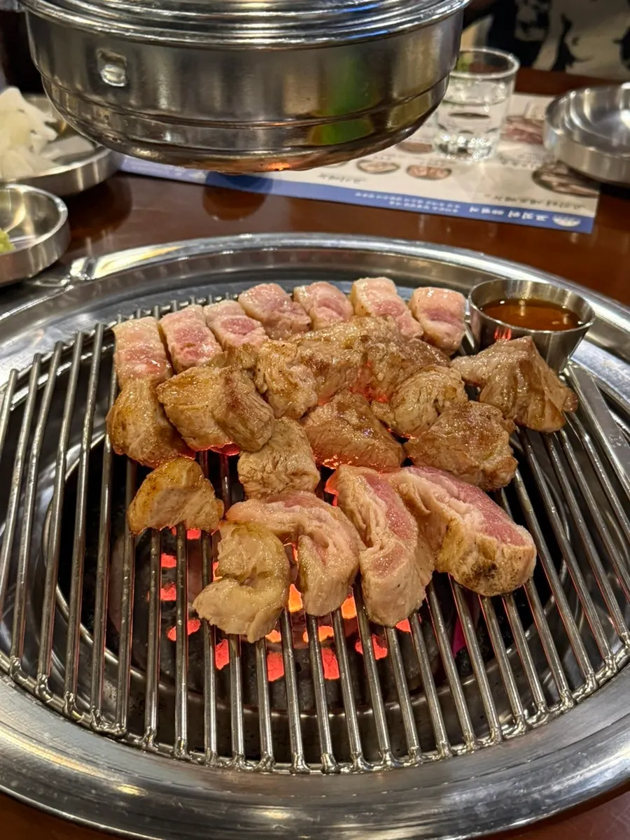 Aged pork belly grilling on the tabletop grill