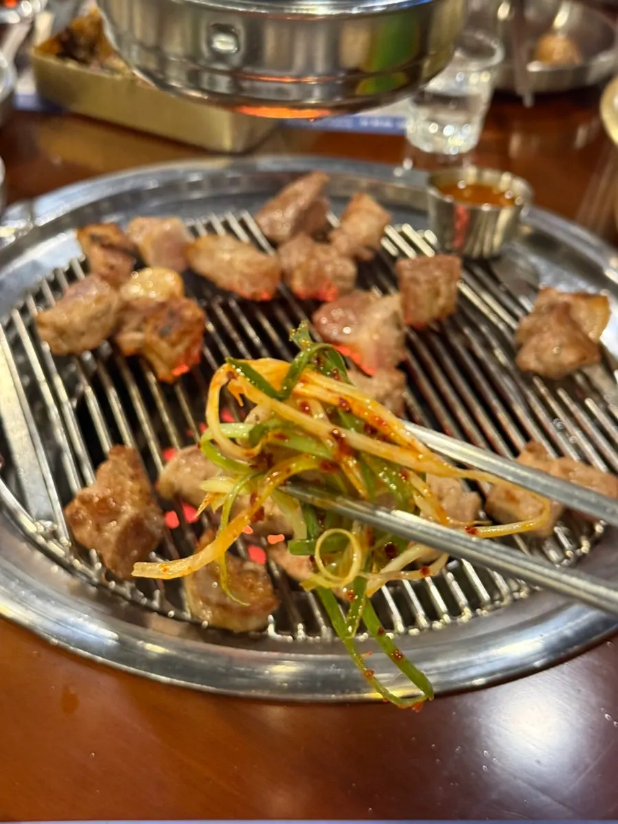 Dipping grilled meat into one of the sauces