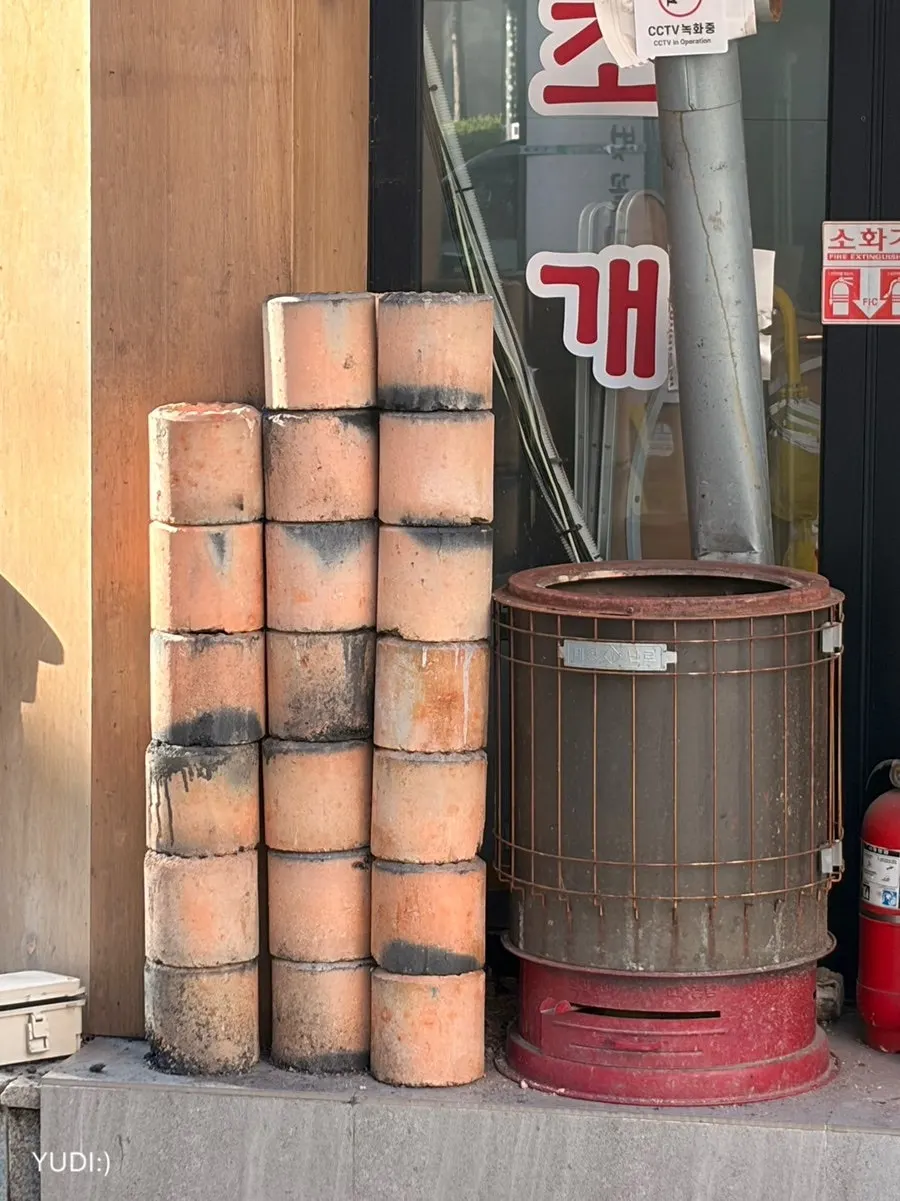 Charcoal briquettes stacked in front of the restaurant