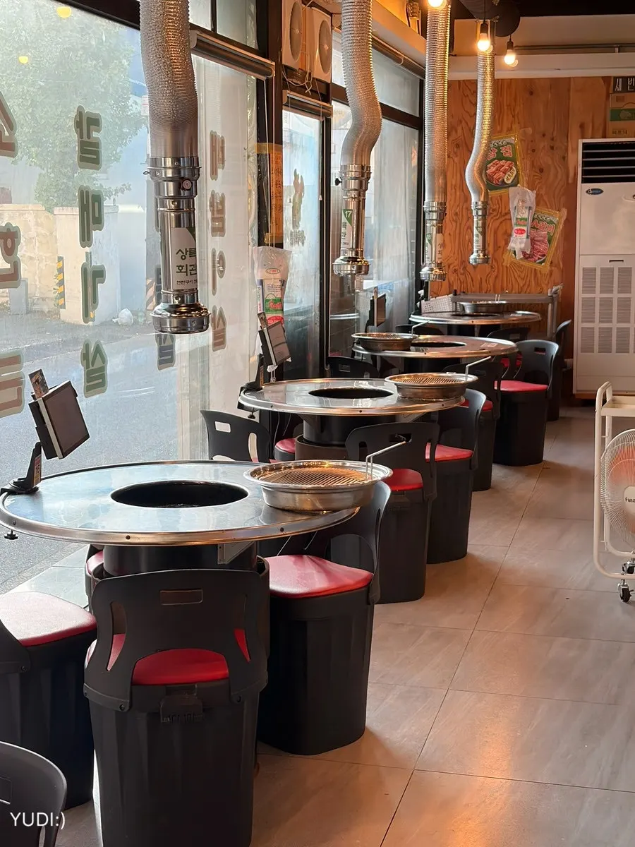 Interior of the charcoal-grill restaurant with round tables