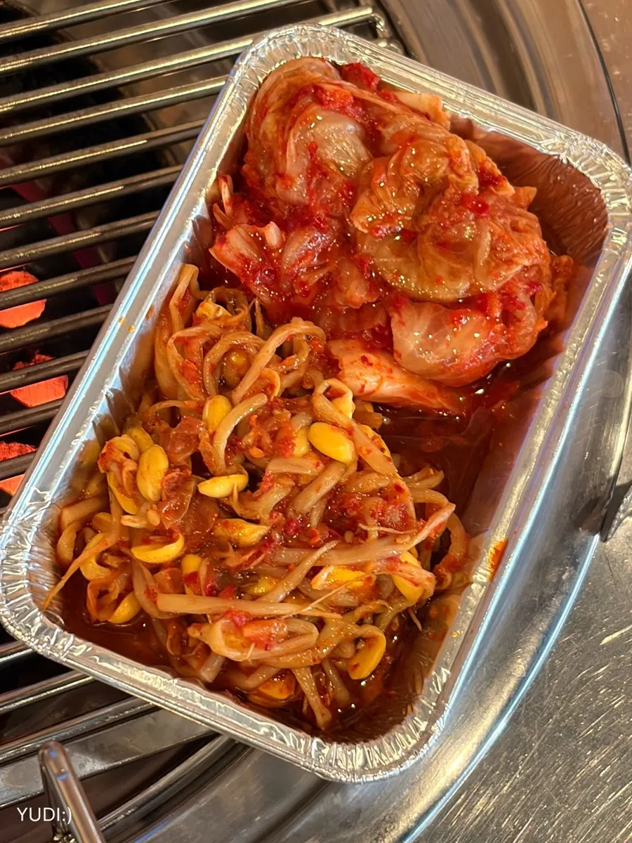 Bean sprouts and kimchi served wrapped in foil