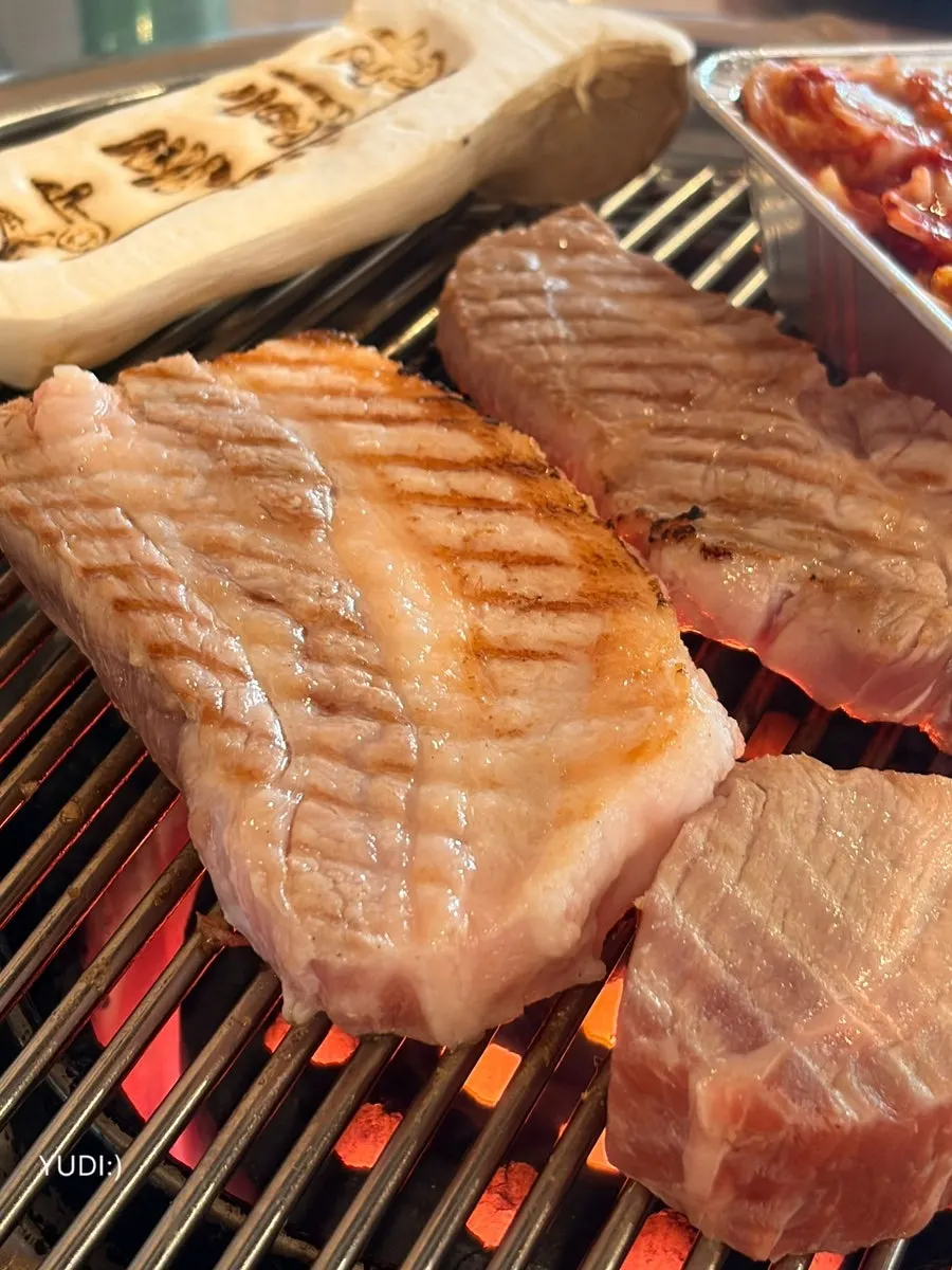 Pork browning nicely over charcoal