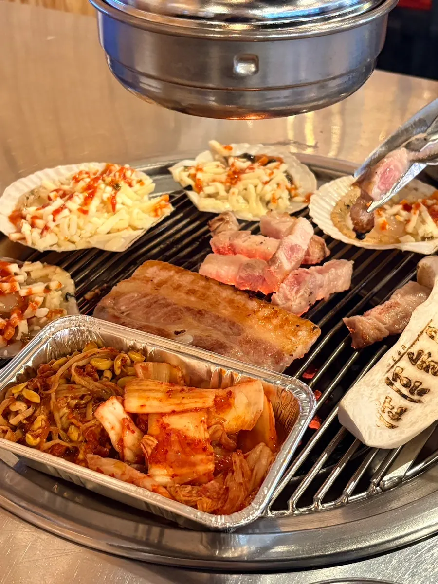 Table setting with brick-shaped pork belly and cheese-topped scallops