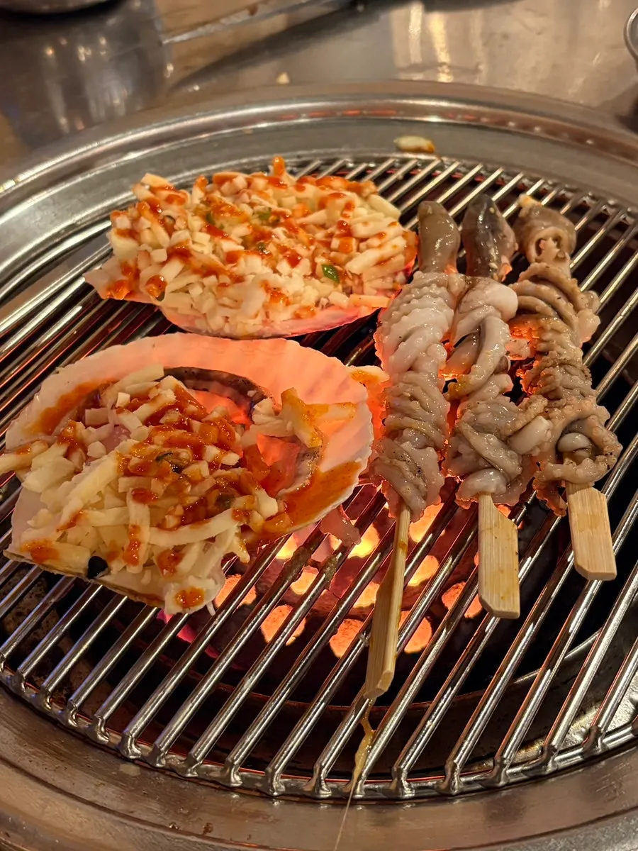 Five additional grilled octopus skewers ordered