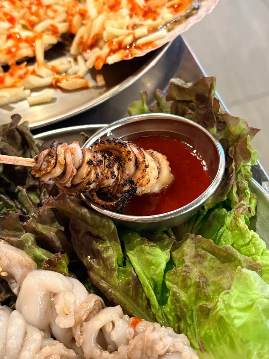 Smoky grilled octopus skewers with vinegar-chili sauce