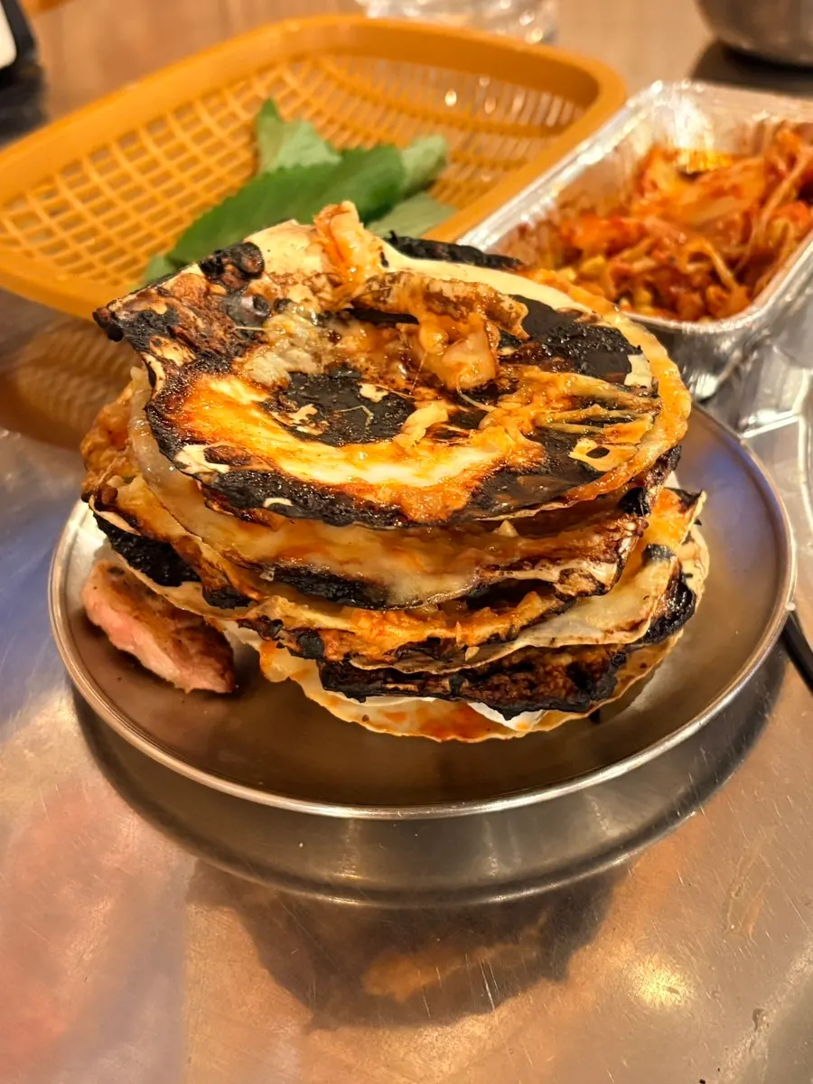 A single bite-sized grilled octopus skewer